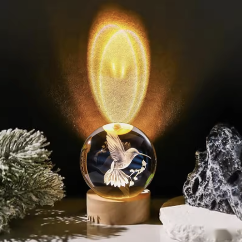 Lampe à poser boule colibri allumée avec halo lumineux Image